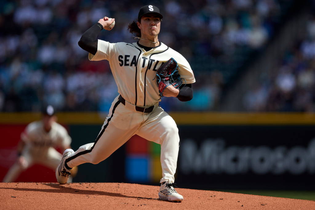 Seattle Mariners starting pitcher Bryan Woo throws against the Texas Rangers during the first inning in a baseball game Sunday, April 19, 2026, in Seattle. (AP Photo/John Froschauer)