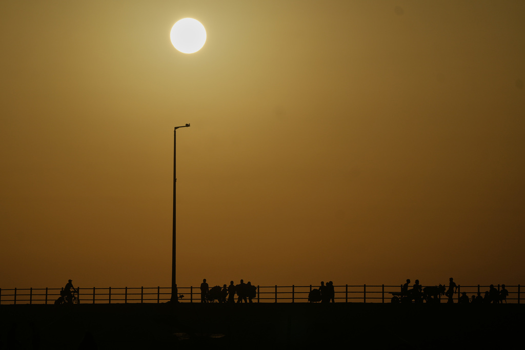 Displaced Palestinians flee northern Gaza carrying their belongings along the coastal road near Wadi Gaza, Thursday, Oct. 2, 2025. (AP Photo/Abdel Kareem Hana)