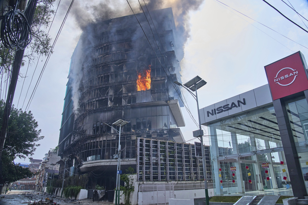 Flames rise from Hilton hotel after it was set on fire in Kathmandu, Nepal, Wednesday, Sept.10, 2025. (AP Photo/Niranjan Shrestha)