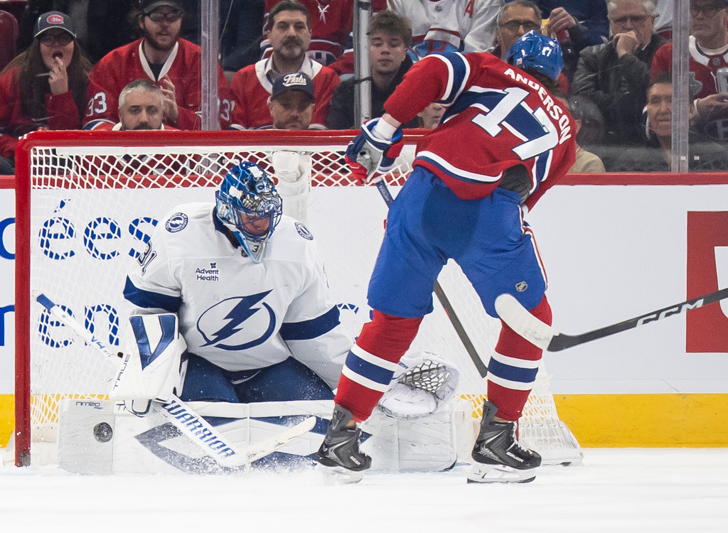 Tampa Bay Lightning goaltender Jonas Johansson (31) makes a save on Montreal Canadiens' Josh Anderson (17) during second period NHL hockey action in Montreal on Tuesday, Dec. 9, 2025. (Christopher Katsarov/The Canadian Press via AP)