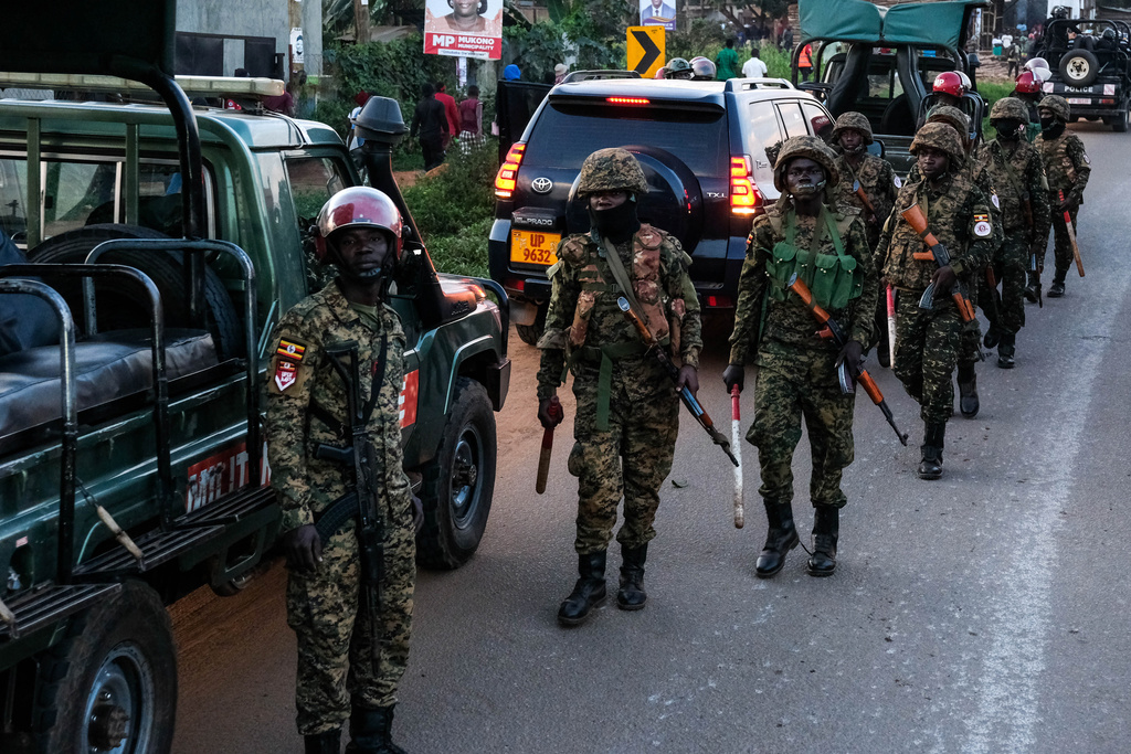 Ugandan security forces patrol a street during a campaign rally for opposition presidential candidate Robert Kyagulanyi Ssentamu who is known as Bobi Wine, ahead of elections, in Mukono, Uganda, Friday, Jan. 9, 2026. (AP Photo/Hajarah Nalwadda)