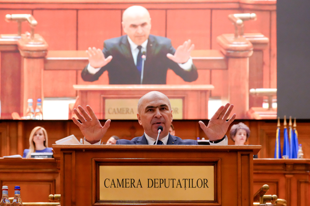 Romanian Prime Minister Ilie Bolojan addresses a parliament session ahead of a no confidence vote in Bucharest, Romania, Tuesday, May 5, 2026. (AP Photo/Vadim Ghirda)