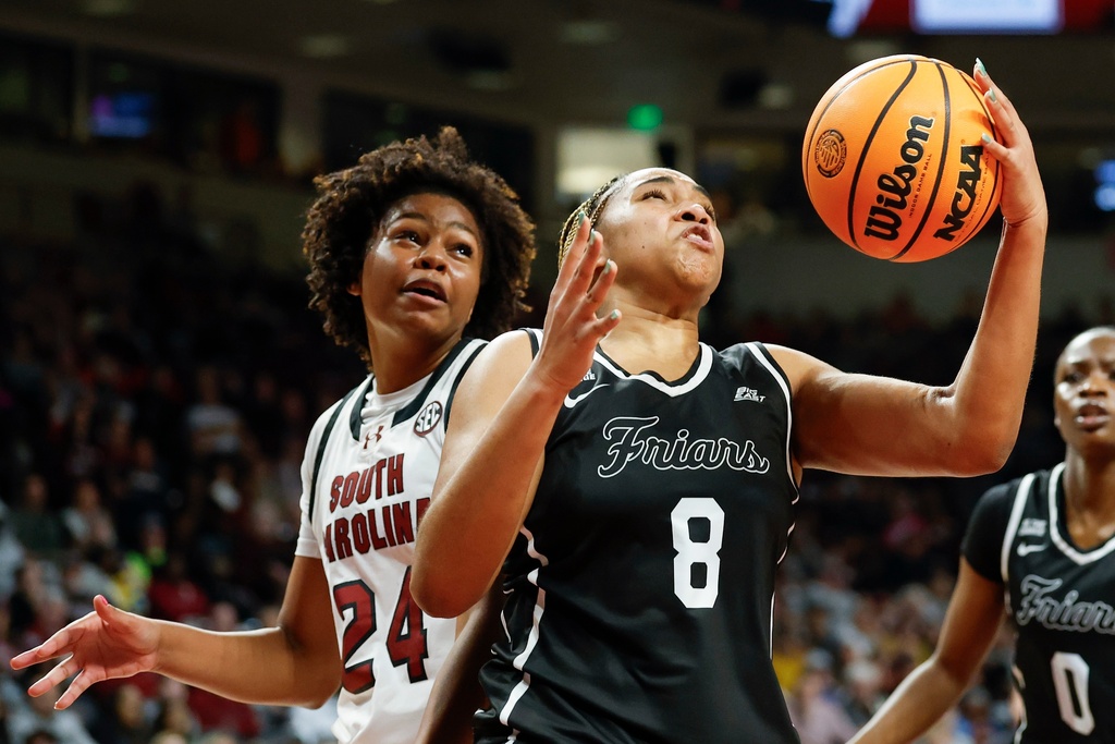 Providence forward Nalani Kaysia (8) pulls down a rebound against South Carolina guard Ayla McDowell during the second half of an NCAA college basketball game in Columbia, S.C., Sunday, Dec. 28, 2025. (AP Photo/Nell Redmond)