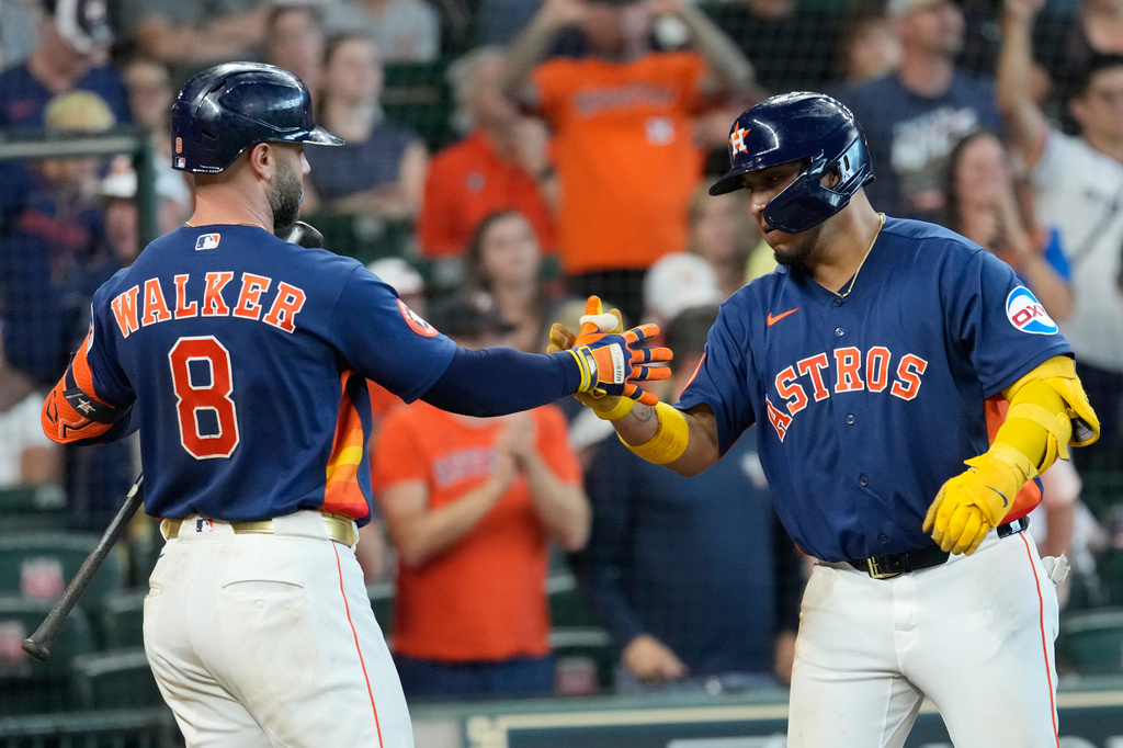 Houston Astros' Isaac Paredes, right, celebrates with Christian Walker (8) after hitting a home run against the Tampa Bay Rays during the sixth inning of a baseball game Sunday, July 5, 2026, in Houston. (AP Photo/David J. Phillip)