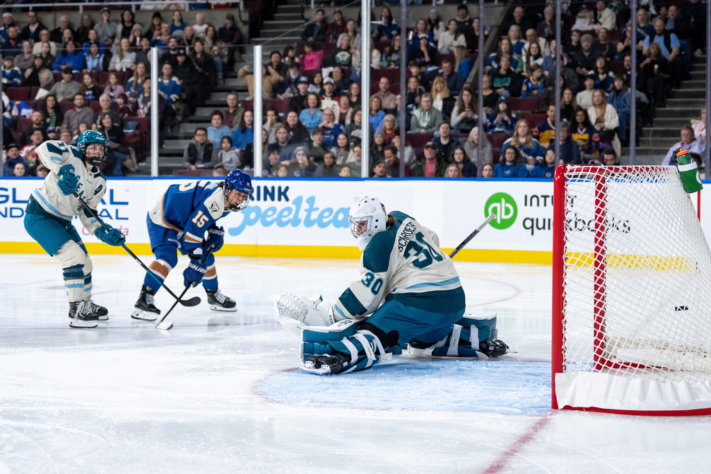 Vancouver Goldeneyes' Gabby Rosenthal (15) scores on Seattle Torrent goaltender Corinne Schroeder (30) as Emily Brown (11) defends during the third period of a PWHL hockey game in Vancouver, on Friday, Nov. 21, 2025. (Ethan Cairns/The Canadian Press via AP)