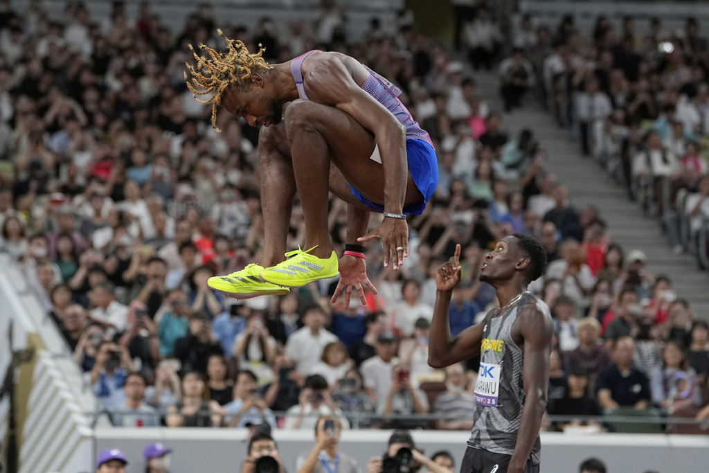 United States' Noah Lyles leaps ahead of his men's 200 meters semifinal at the World Athletics Championships in Tokyo, Thursday, Sept. 18, 2025. (AP Photo/Ashley Landis)