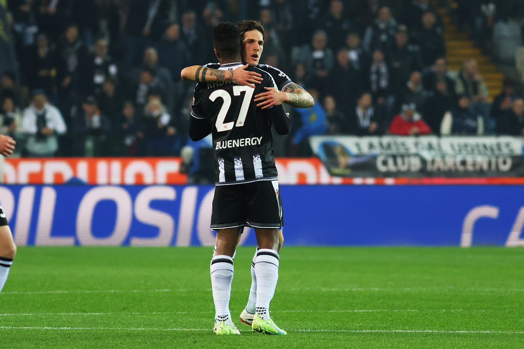 Udinese's Christian Kabasele, back, celebrates after scoring during the Italian Serie A soccer match between Udinese and Fiorentina in Udine, Italy, Monday, March 2, 2026. (Andrea Bressanutti/LaPresse via AP)