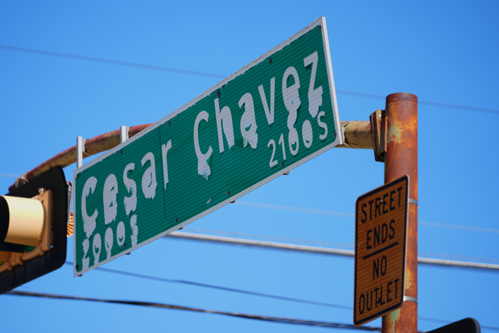 A worn sign identifies Cesar Chavez Boulevard in Dallas, Thursday, March 19, 2026. (AP Photo/Julio Cortez)