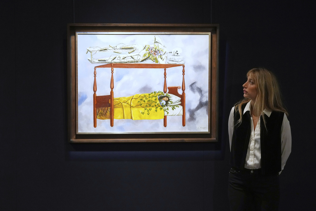 A painting by Frida Kahlo called El sueño (La cama) is displayed at Sotheby's auction rooms, the painting estimated at 40-60 million US dollars is part of a collection of surrealist masterpieces unveiled in London ahead of their sale in New York, Friday, Sept. 19, 2025. (AP Photo/Kirsty Wigglesworth)