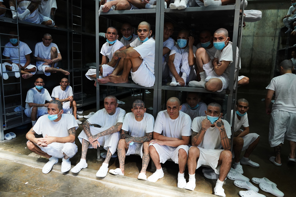 Prisoners sit inside a cell at the mega the prison known as Detention Center Against Terrorism (CECOT) in Tecololuca, El Salvador, Friday, Jan. 30, 2026, during a tour for Chile's President-elect Jose Antonio Kast. (AP Photo/Salvador Melendez)