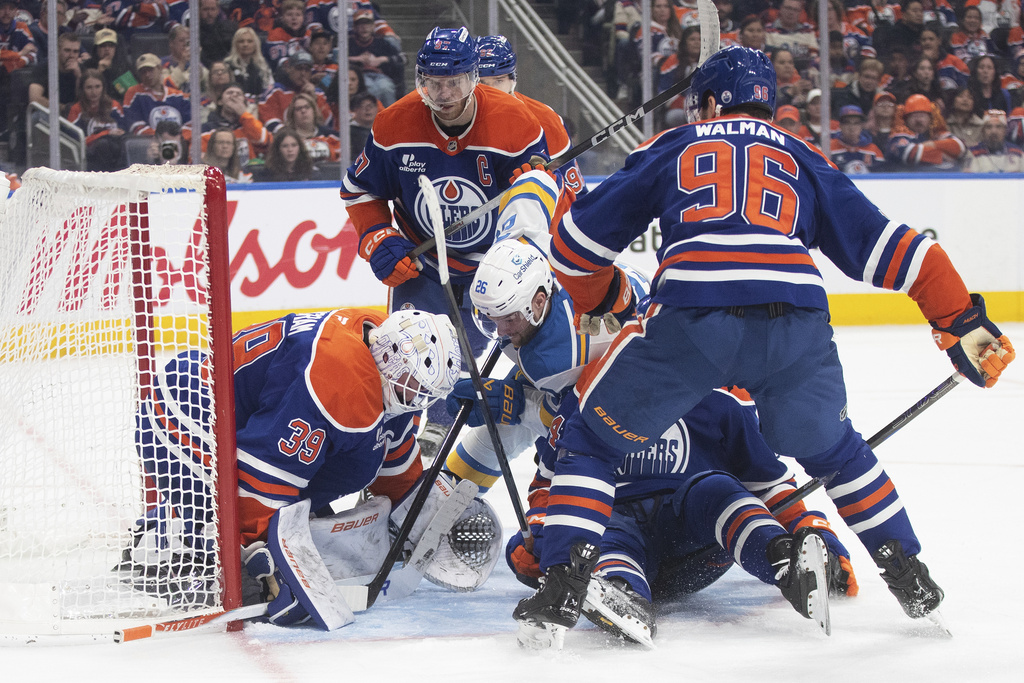 St. Louis Blues' Nathan Walker (26) is stopped by Edmonton Oilers' goalie Connor Ingram (39) during the third period of an NHL hockey game in Edmonton, Alberta, Sunday, Jan. 18, 2026. (Jason Franson/The Canadian Press via AP)