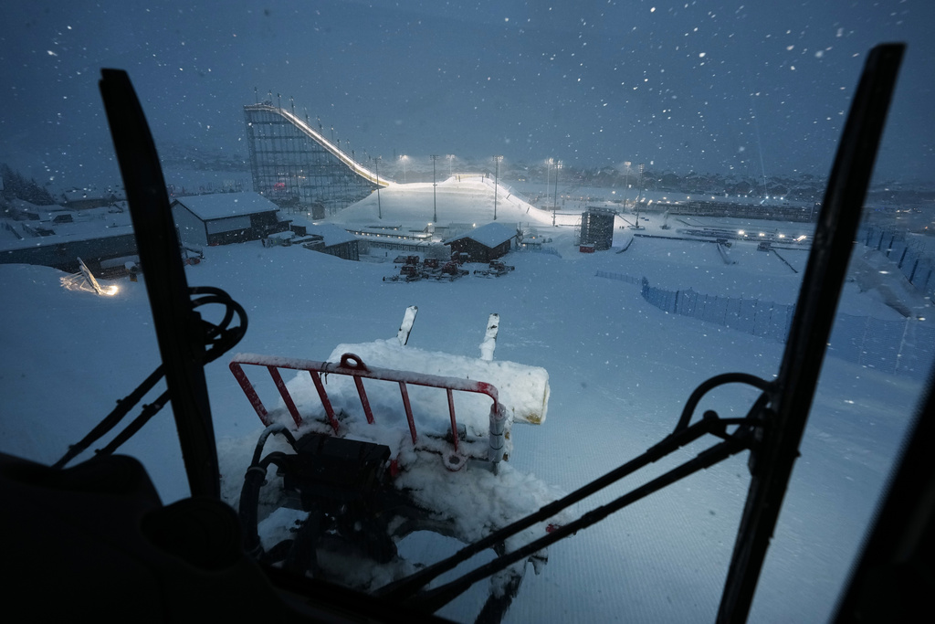 Snowcat driver Oliviero Galli cleans up courses after a weather delay postponed the women's freestyle skiing halfpipe final at the 2026 Winter Olympics, in Livigno, Italy, Saturday, Feb. 21, 2026. (AP Photo/Andy Bao)