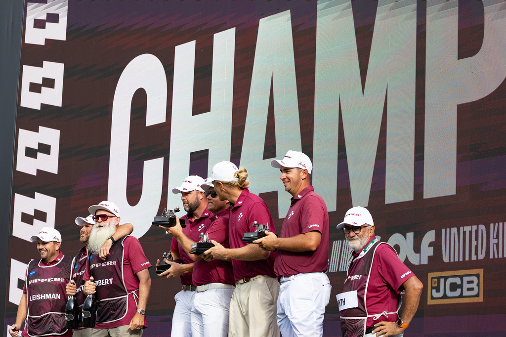 Team champions captain Cameron Smith, Marc Leishman, Lucas Herbert and Travis Smyth, of Ripper GC, and their caddies celebrate onstage after their first-place win following the final round of the LIV Golf United Kingdom golf tournament Sunday, July 26, 2026, in Rocester, England. (Jon Ferrey/LIV Golf via AP)