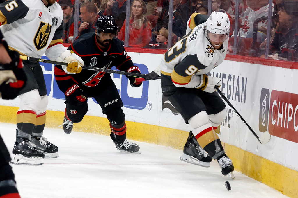 Vegas Golden Knights' Mitch Marner (93) controls the puck in front of Carolina Hurricanes' Seth Jarvis (24) during the second period in Game 2 of the NHL hockey Stanley Cup Final series in Raleigh, N.C., Thursday, June 4, 2026. (AP Photo/Karl DeBlaker)