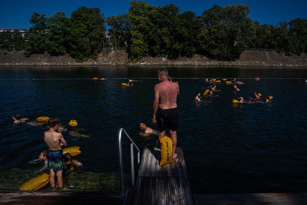 People swim in the Seine River, Saturday, July 4, 2026 in Paris. (AP Photo/Aurelien Morissard)
