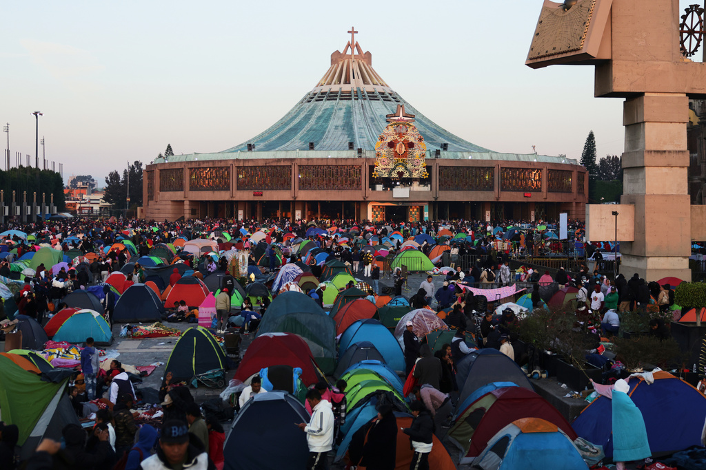 Pilgrims gather outside the Basilica of Our Lady of Guadalupe in Mexico City, on her feast day, Friday, Dec. 12, 2025. (AP Photo/Claudia Rosel)