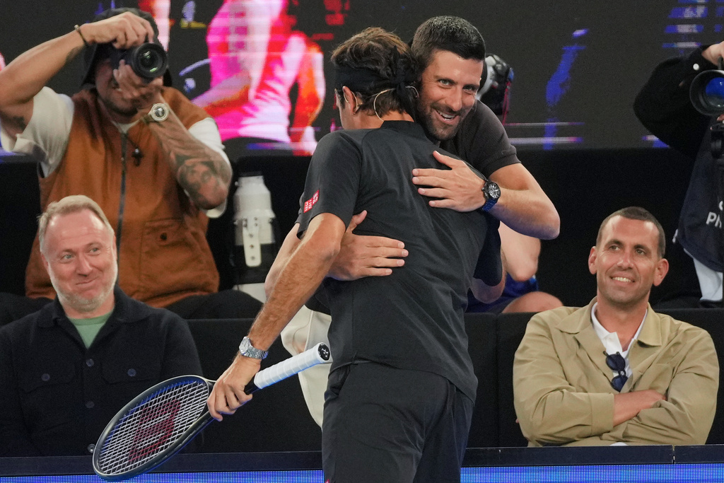 Novak Djokovic, right, of Serbia embraces Roger Federer of Switzerland during the Opening Ceremony for the Australian Open tennis championship in Melbourne, Australia, Saturday, Jan. 17, 2026. (AP Photo/Dita Alangkara)