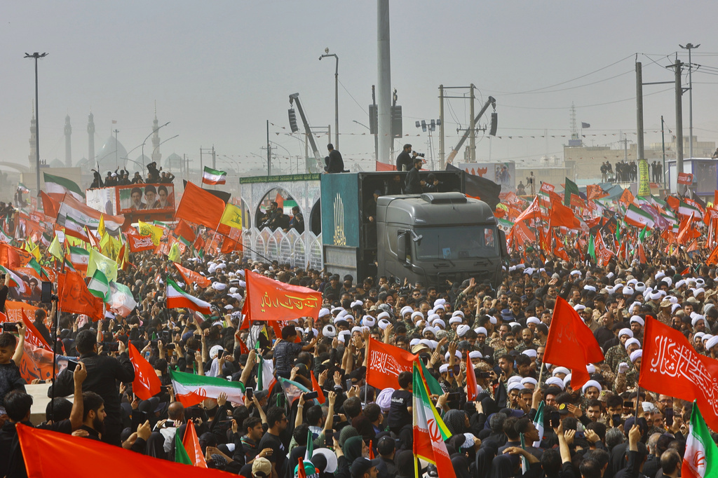 A truck carrying the coffins of the late Iranian Supreme Leader Ayatollah Ali Khamenei and members of his family makes its way through mourners during the funeral procession in Qom, the heart of religious studies in Iran, Tuesday July 7, 2026. (Mehdi Khezrian/ISNA via AP)