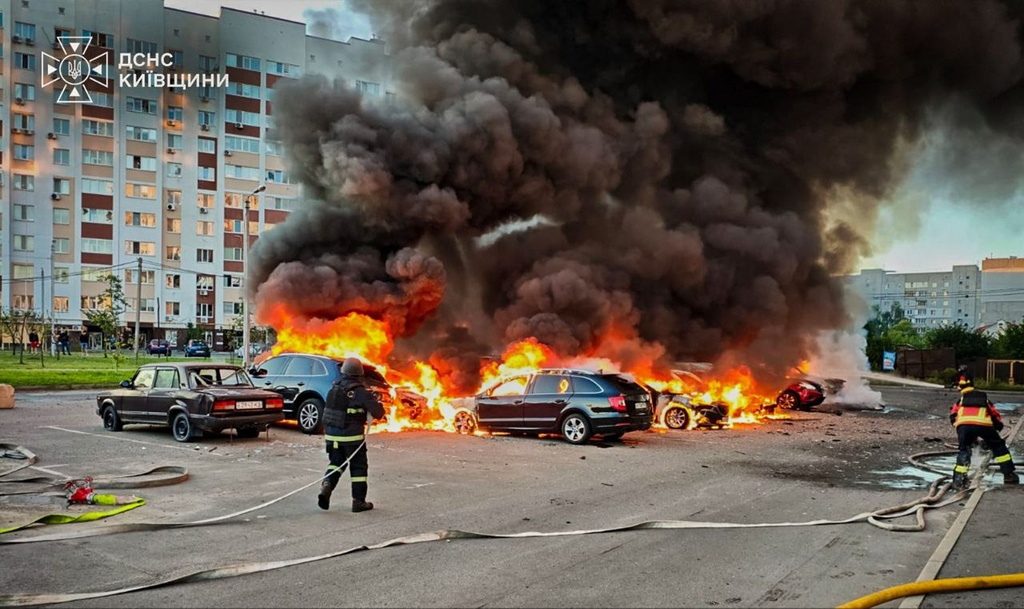 In this photo provided by the Ukrainian Emergency Service, cars burn as firefighters try to put out a fire following a Russian drone attack in Kyiv region, Ukraine, Friday, Aug. 28, 2026. (Ukrainian Emergency Service via AP)