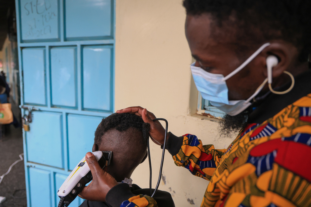 A barber shaves a patients hair during a grooming session at the largest mental health referral hospital, Mathari in Nairobi, Kenya, Tuesday, June 30, 2026. (AP Photo/Andrew Kasuku)