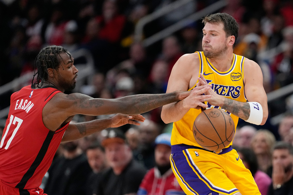Houston Rockets' Tari Eason (17) knocks the ball away from Los Angeles Lakers' Luka Doncic during the second half of an NBA basketball game Monday, March 16, 2026, in Houston. (AP Photo/David J. Phillip)