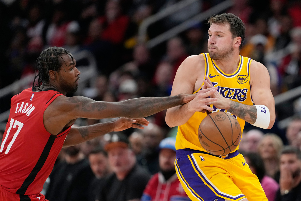 Houston Rockets' Tari Eason (17) knocks the ball away from Los Angeles Lakers' Luka Doncic during the second half of an NBA basketball game Monday, March 16, 2026, in Houston. (AP Photo/David J. Phillip)