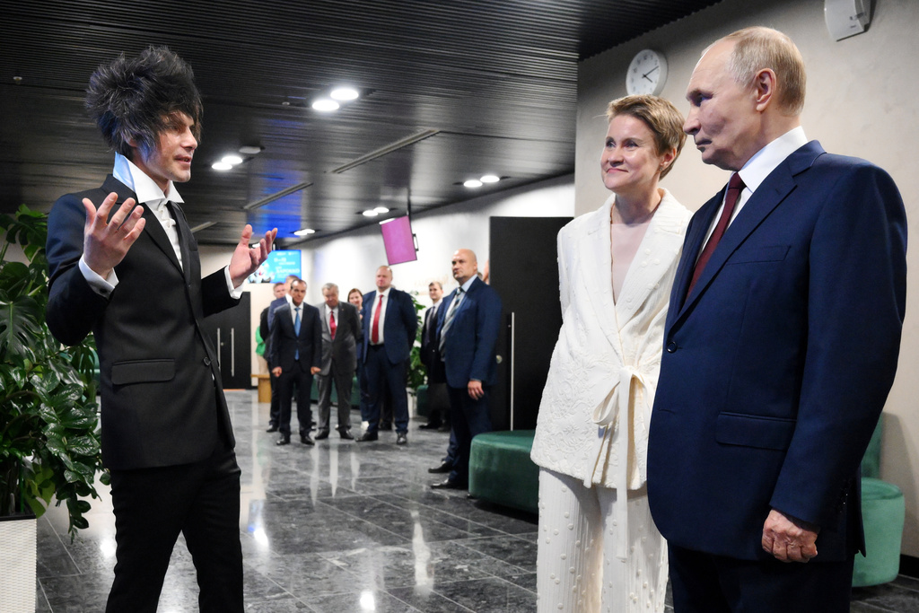 Russian President Vladimir Putin, right, accompanied by Board Chairwoman of the Sirius Federal Territory and Head of the Talent and Success Foundation Elena Shmeleva, listens to Chief Architect Andrei Litvinov, left, during a visit to the newly opened Sirius Concert Centre of the Sirius Federal Territory, Krasnodar Region, Russia, Friday, Oct. 3, 2025. (Grigory Sysoyev, Sputnik, Kremlin Pool Photo via AP)