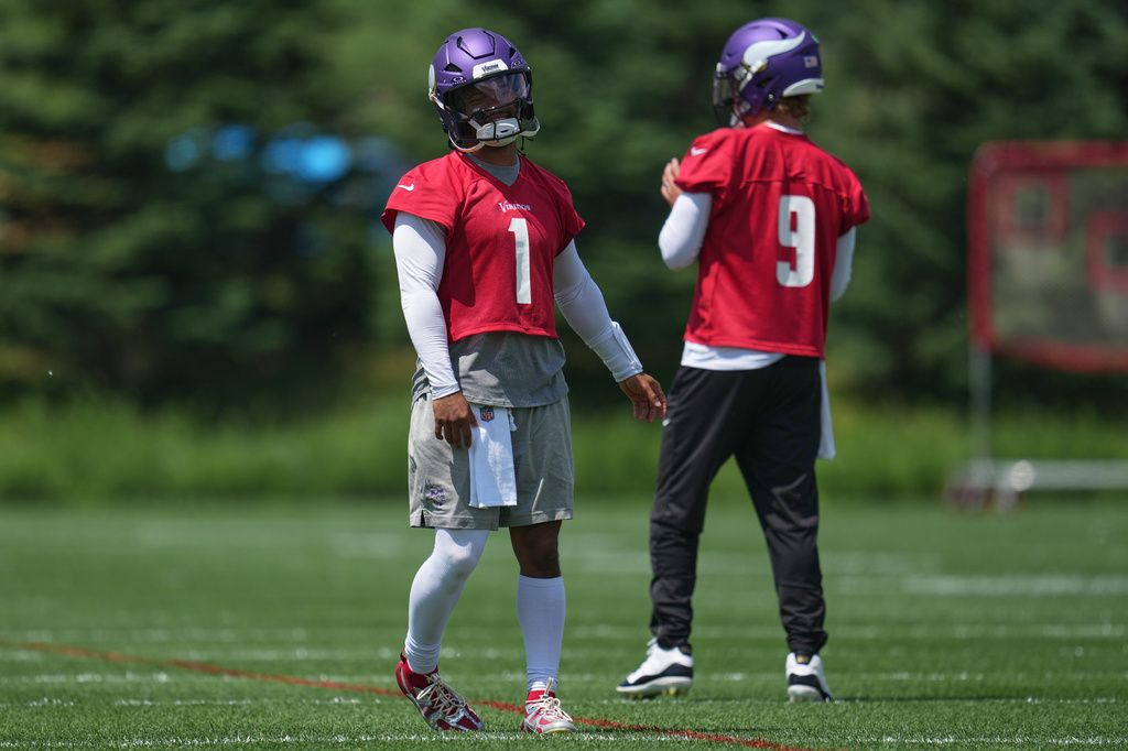 Minnesota Vikings quarterbacks Kyler Murray (1) and J.J. McCarthy (9) stand on the field during an NFL football practice Tuesday, June 9, 2026 in Eagan, Minn. (AP Photo/Abbie Parr)