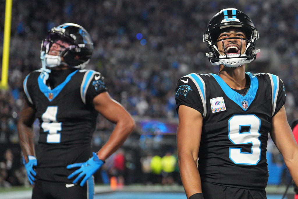 Carolina Panthers quarterback Bryce Young (9) celebrates after Carolina Panthers wide receiver Tetairoa McMillan (4) scores a touchdown during an NFL football game against the Detroit Lions in Charlotte, N.C., Sunday, Oct. 4, 2026. (AP Photo/Erik Verduzco)