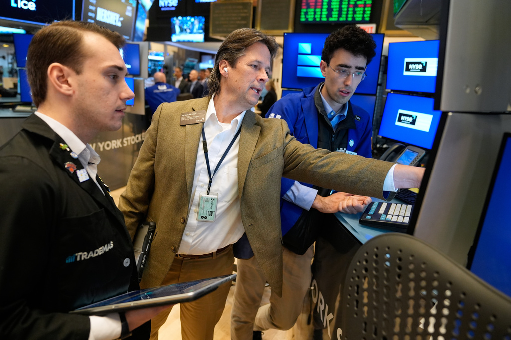 Patrick McKeon, center, works on the floor at the New York Stock Exchange in New York, Tuesday, March 31, 2026. (AP Photo/Seth Wenig)