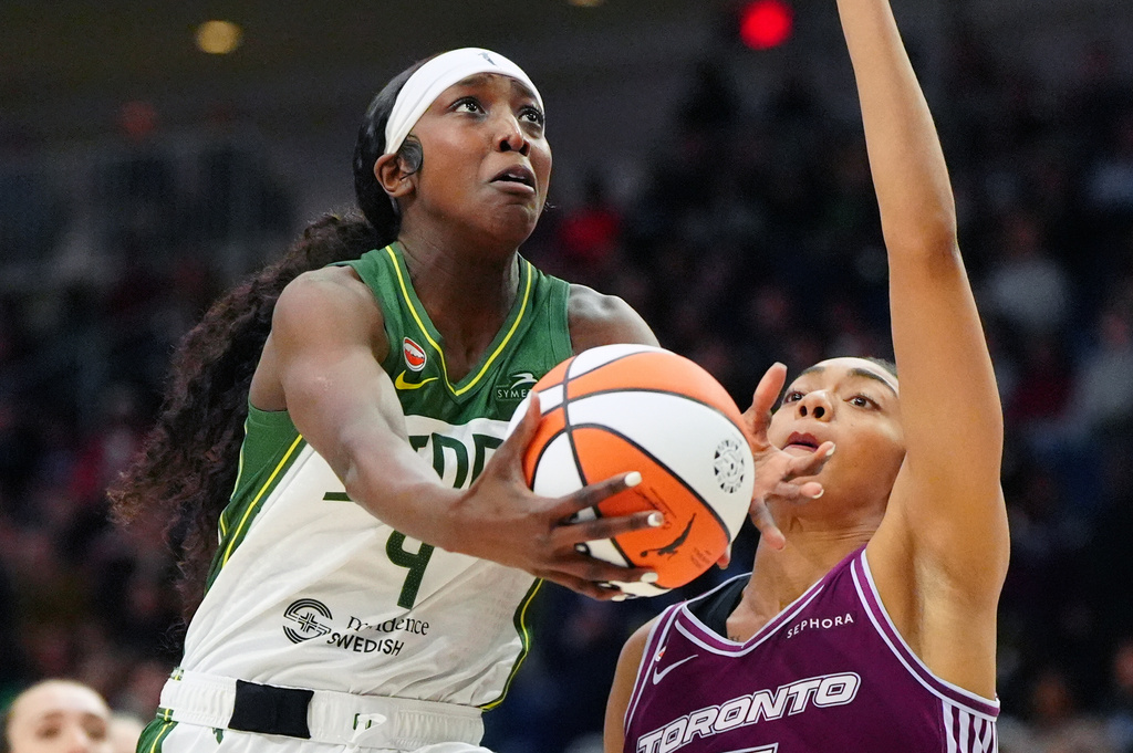Seattle Storm's Flau'jae Johnson (4) drives past Toronto Tempo's Teonni Key during the first half of a WNBA basketball game in Toronto, Wednesday, May 13, 2026. (Frank Gunn/The Canadian Press via AP)