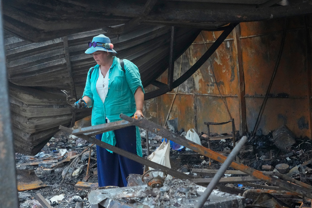 An owner looks at the ruins of city market place following Russian missile attack in Kyiv, Ukraine, Thursday, July 30, 2026. (AP Photo/Efrem Lukatsky)