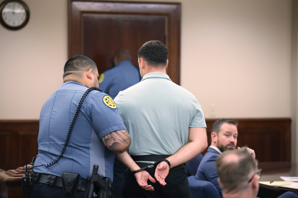 Jake Lang is escorted out of a hearing for Dalton Eatherly, who goes by the moniker Chud the Builder, at the Montgomery County Courthouse, Thursday, May 21, 2026, in Clarksville, Tenn. (AP Photo/Adin Parks)