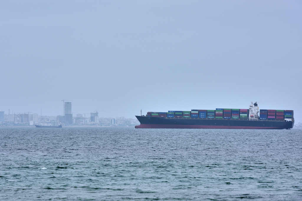 A container ship is seen in the Strait of Hormuz off the coast of Qeshm Island, Iran, Saturday, April 18, 2026. (AP Photo/Asghar Besharati)