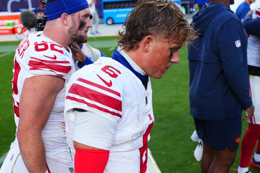 New York Giants tight end Daniel Bellinger, left, and quarterback Jaxson Dart walk off the field after an NFL football game against the Denver Broncos in Denver, Sunday, Oct. 19, 2025. (AP Photo/Jack Dempsey) New York Giants tight end Daniel Bellinger, left, and quarterback Jaxson Dart walk off the field after an NFL football game against the Denver Broncos in Denver, Sunday, Oct. 19, 2025. (AP Photo/Jack Dempsey)