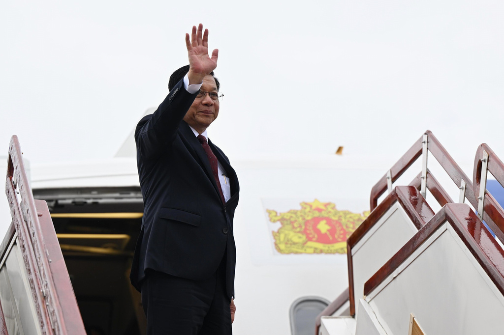 In this photo released by Myanmar President Office, Myanmar President Min Aung Hlaing waves his hand upon his departure to Russia, at the Naypyitaw international airport Monday, Aug. 17, 2026, in Naypyitaw, Myanmar. (Myanmar President Office via AP)