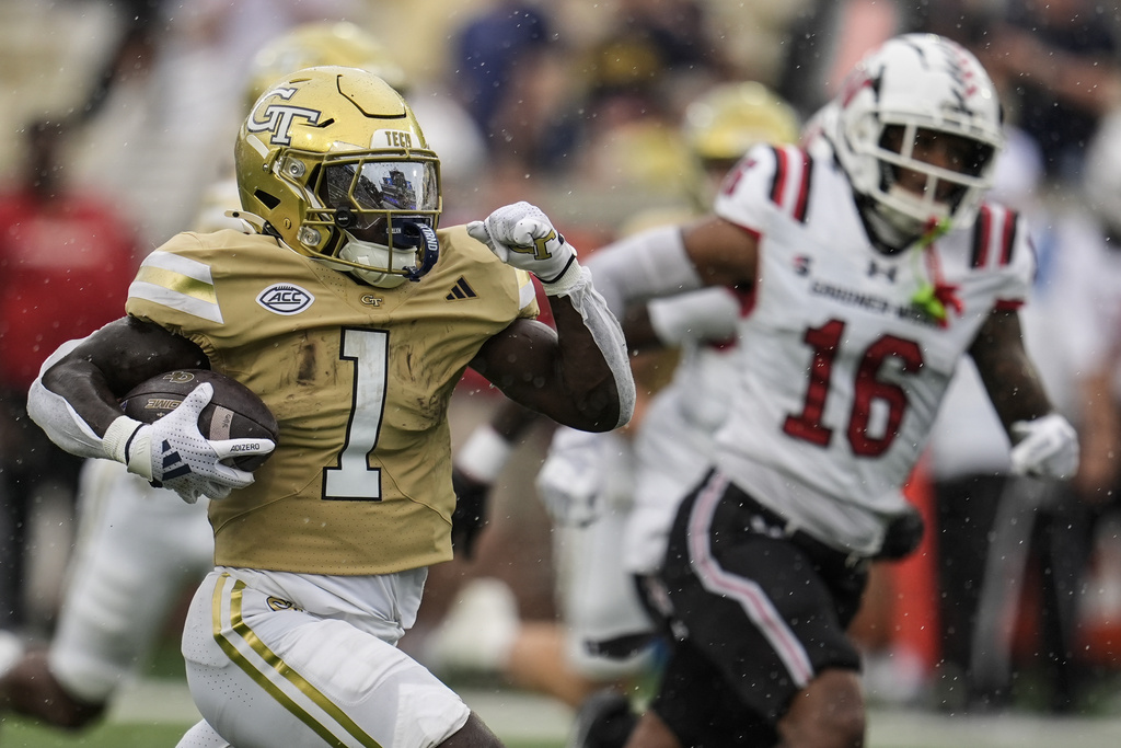 Georgia Tech running back Jamal Haynes (1) runs for a touchdown against Gardner-Webb safety Josiah Harris (16) during the first half of an NCAA college football game, Saturday, Sept. 6, 2025, in Atlanta. (AP Photo/Mike Stewart)