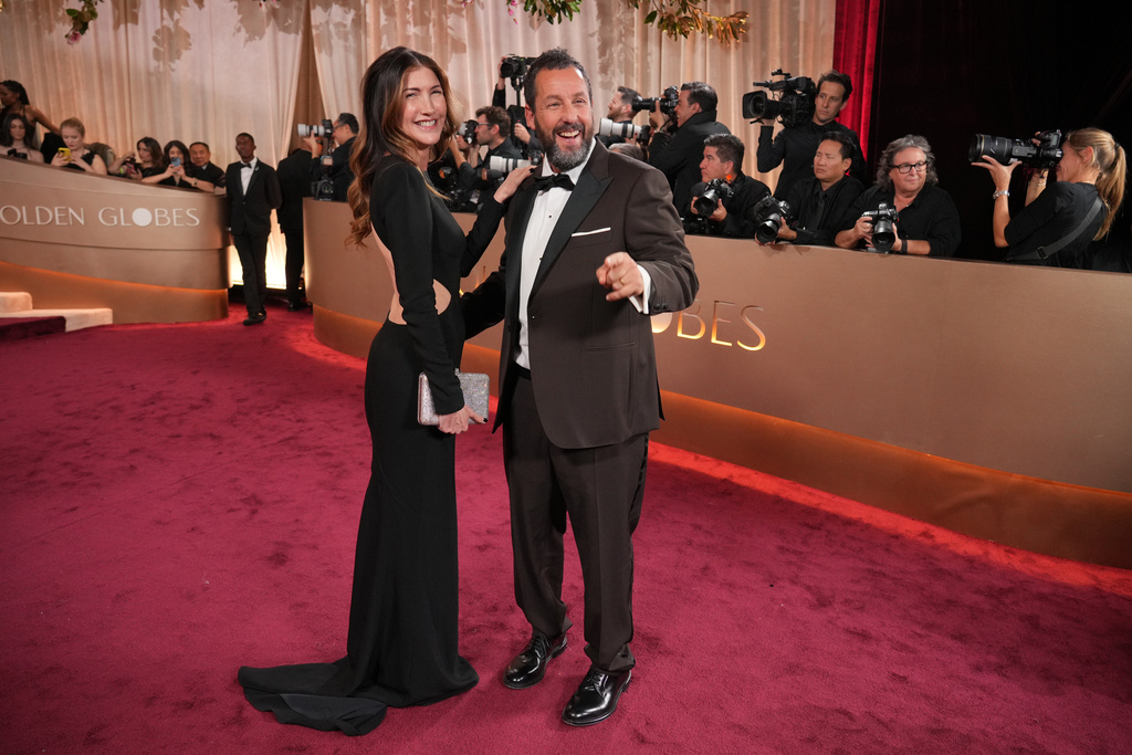 Jackie Sandler, left, and Adam Sandler arrive at the 83rd Golden Globes on Sunday, Jan. 11, 2026, at the Beverly Hilton in Beverly Hills, Calif. (Photo by Jordan Strauss/Invision/AP)