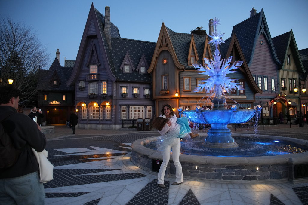 Visitors enjoy the new theme World of Frozen during its inauguration at Disneyland Paris in Marne-la-Vallee, east of Paris, Saturday, March 28, 2026. (AP Photo/Christophe Ena)