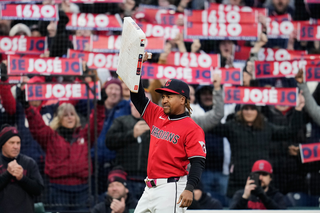 Cleveland Guardians third baseman José Ramírez holds the base after being presented with it after the fifth inning of a baseball game against the Kansas City Royals to commemorate his record 1,620 games as a Cleveland Indian/Cleveland Guardian in Cleveland, Monday, April 6, 2026. (AP Photo/Sue Ogrocki)