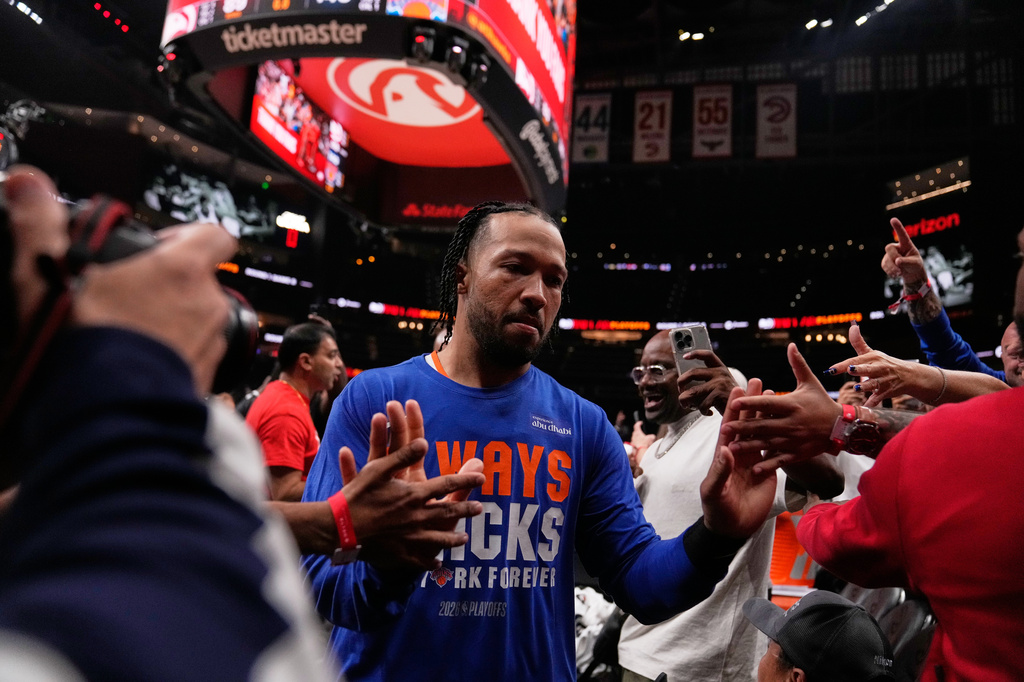 New York Knicks guard Jalen Brunson (11) high fives fans as he leaves the court in the second half during Game 6 in a first-round NBA basketball playoffs series Thursday, April 30, 2026, in Atlanta. (AP Photo/Brynn Anderson)