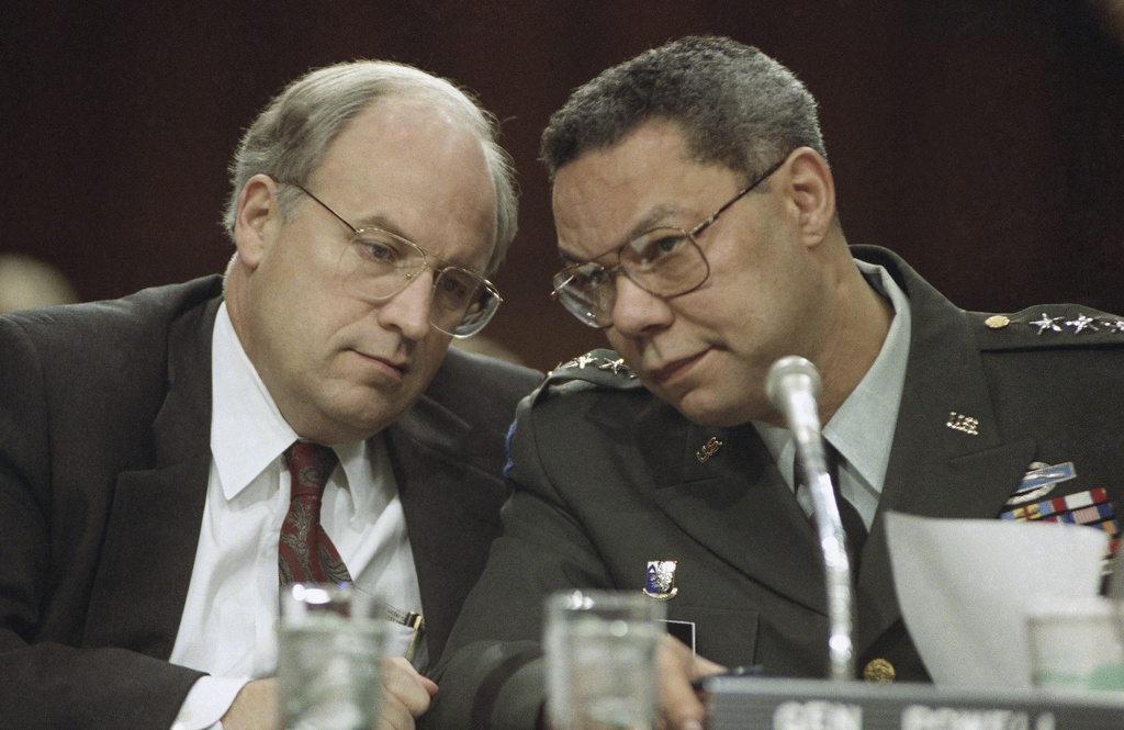 FILE - Secretary of Defense Dick Cheney, left, and Chairman of the Joint Chiefs, Gen. Colin Powell, huddle prior to testifying before the Senate Armed Services Committee, Thursday, Feb. 21, 1991 on Capitol Hill in Washington. (AP Photo/John Duricka, file)