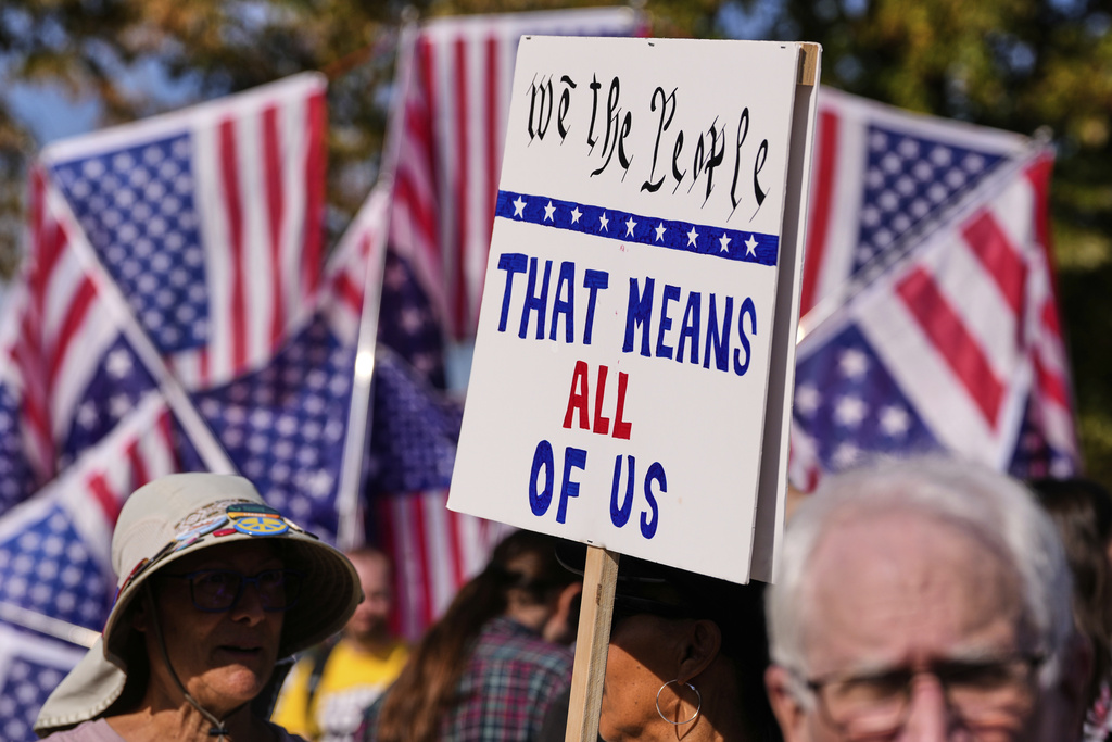 Protesters gather outside the U.S. Immigration and Customs Enforcement regional field office, Tuesday, Sept. 16, 2025, in Burlington, Mass. (AP Photo/Charles Krupa)
