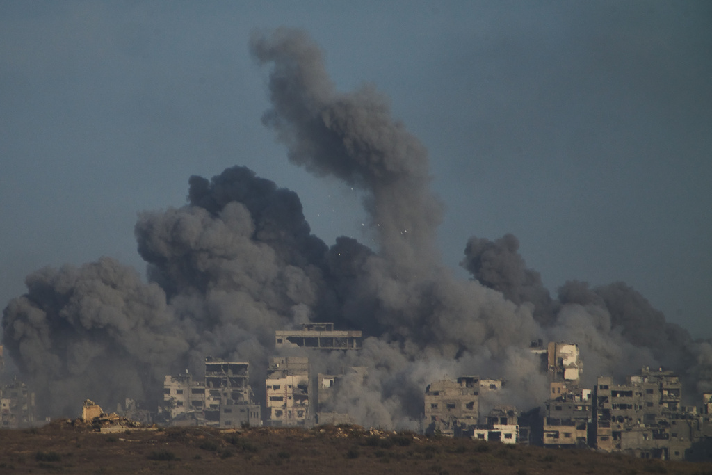 Smoke billows over Gaza Strip following an Israeli bombardment, as seen from southern Israel, Sunday, Oct. 5, 2025. (AP Photo/Ariel Schalit)
