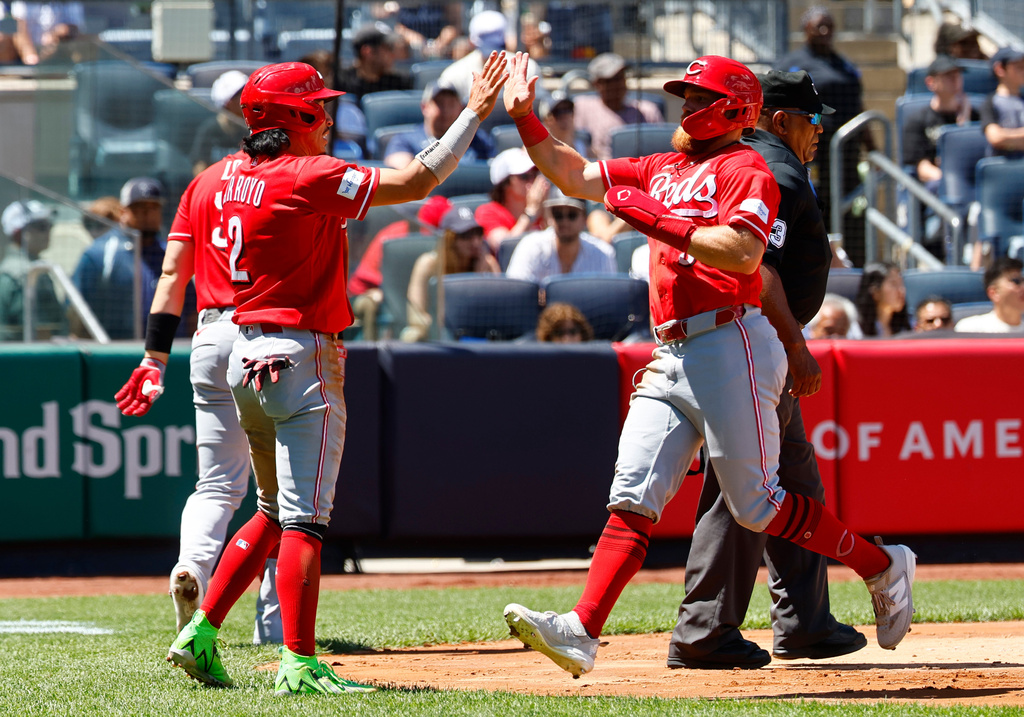 Cincinnati Reds' Edwin Arroyo (2) and Blake Dunn (59) react after scoring during the third inning of a baseball game against the New York Yankees, Saturday, June 20, 2026, in New York. (AP Photo/Noah K. Murray)