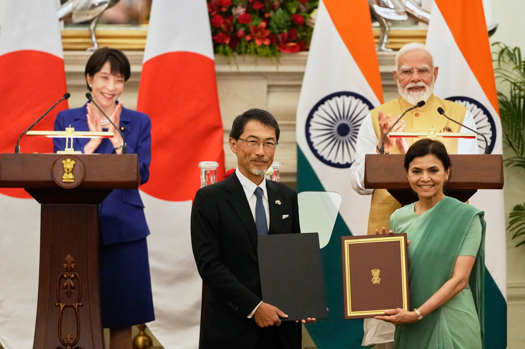 Japan's Prime Minister Sanae Takaichi, left, and India's Prime Minister Narendra Modi, right, applaud as Japan's ambassador to India Ono Keiichi, center left, and India's ambassador to Japan Nagma Mohamed Mallick hold copies of a signed bilateral agreement after their delegation level meeting in New Delhi, India, Thursday, July 2, 2026. (AP Photo/Manish Swarup)