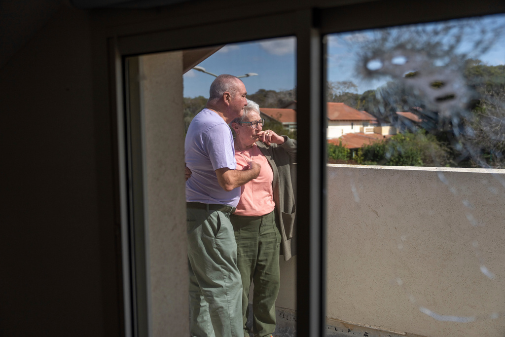FILE - Pete and Gillian Brisley visit the home of their daughter, who was killed along with her two daughters in Hamas' Oct. 7 attack, and their son-in-law, Eli Sharabi, who was taken captive, in Kibbutz Be'eri, southern Israel, Wednesday, Feb. 21, 2024. (AP Photo/Ohad Zwigenberg, File)