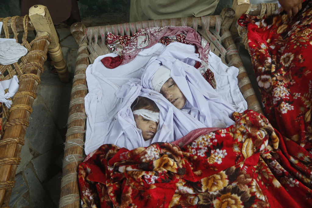 EDS NOTE: GRAPHIC CONTENT - Bodies of children, killed in Friday's flash flooding, seen at a house at a village near Pir Baba, Buner district, in Pakistan's northwest, Saturday, Aug.16, 2025. (AP Photo/Muhammad Sajjad)