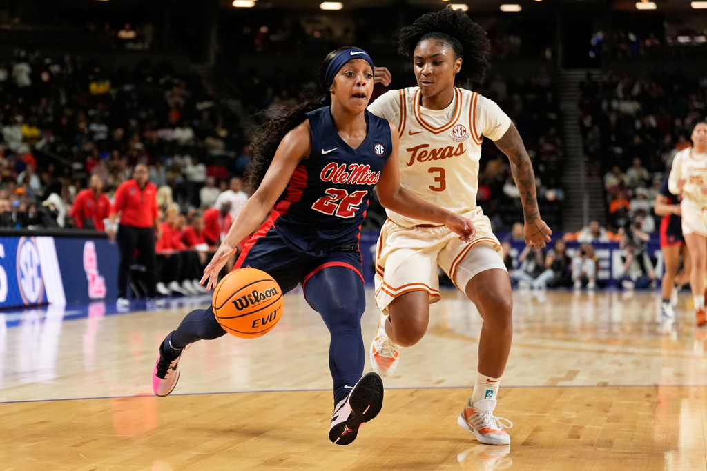 Mississippi guard Denim DeShields drives to the basket past Texas guard Rori Harmon during the first half of an NCAA college basketball game in the semifinals of the Southeastern Conference tournament, Saturday, March 7, 2026, in Greenville, S.C. (AP Photo/Chris Carlson)