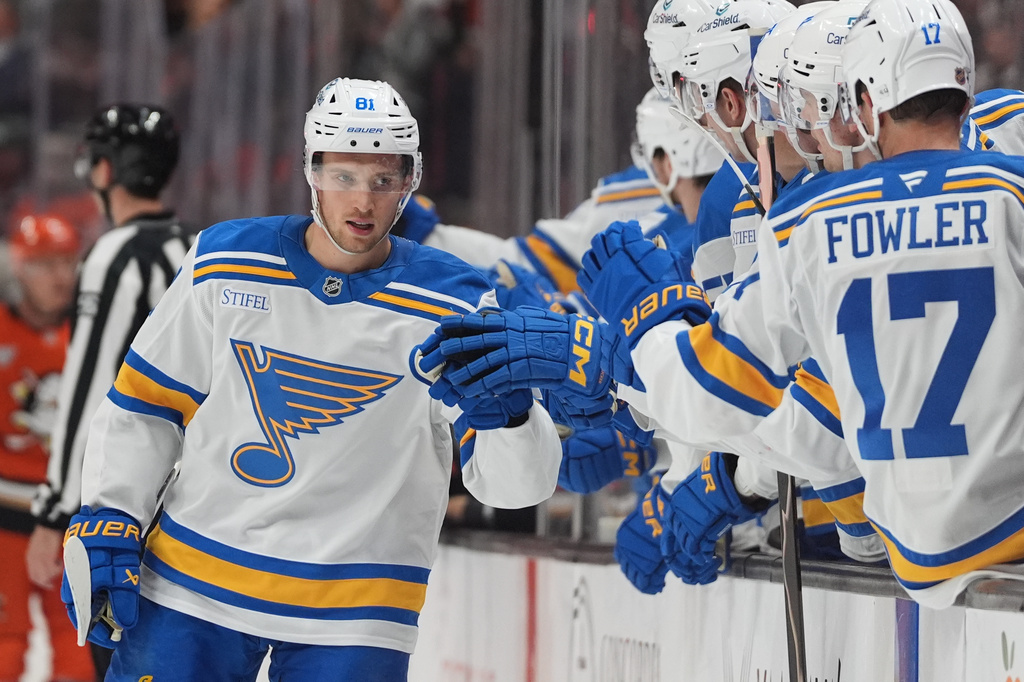 St. Louis Blues left wing Dylan Holloway, left, celebrates his goal with teammates during the first period of an NHL hockey game against the Anaheim Ducks Friday, April 3, 2026, in Anaheim, Calif. (AP Photo/Gregory Bull)